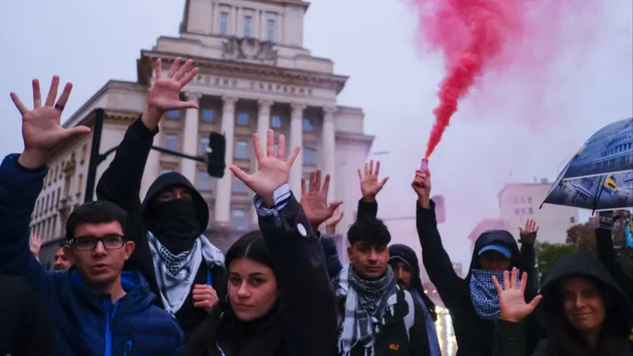 Demonstrators raise open hands in front of Bulgaria's National Assembly during a protest for Abdulrahman's release